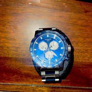 Blue dial tissot watch.